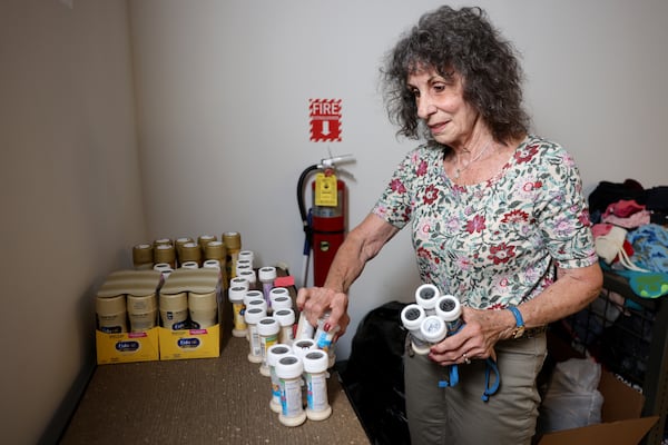 Volunteer Fran Gore places bottles of formula on the shelves in May to be distributed at the Helping Mamas Baby Supply Bank in Norcross. State health officials say they’re now working to boost the formula supply and provide community food programs with extra stock after a widespread shortage. (Jason Getz / Jason.Getz@ajc.com)