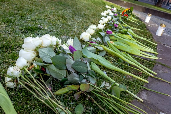 Flowers are laid in the city center of Mannheim, Germany, Tuesday, March 4, 2025, a day after a driver rammed a car into a crowd. (AP Photo/Michael Probst)