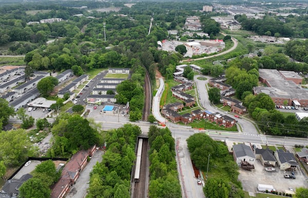 An aerial photograph shows Joseph E. Boone Boulevard NW (left to right), where the MARTA train tracks (top to bottom) cross underneath, on Wednesday, April 24, 2024. (Hyosub Shin / AJC)