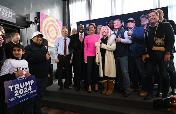 Guest speakers including U.S. Rep. Marjorie Taylor (center) pose for a group photograph during a Team Trump campaign event Monday at the ShinyTop Brewery in Fort Dodge, Iowa. (Hyosub Shin / Hyosub.Shin@ajc.com)