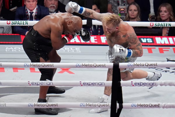 Jake Paul throws a punch at Mike Tyson during their heavyweight boxing match, Friday, Nov. 15, 2024, in Arlington, Texas. (AP Photo/Julio Cortez)