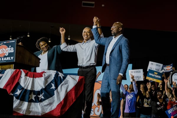 From left: Georgia gubernatorial candidate Stacey Abrams, former President Barack Obama and Sen. Raphael Warnock (D-Ga.)  at an event in College Park on Oct. 28, 2022. (Gabriela Bhaskar/The New York Times)