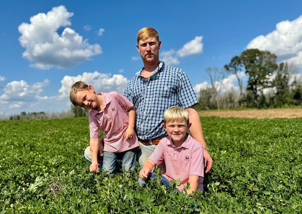 Peanut farmer Riley Davis in a peanut field south of Plains with his sons, Drew (left, 4) and Luke, 7.