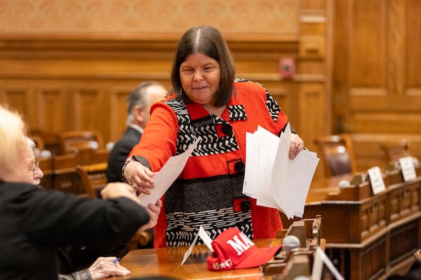 Georgia GOP accounting director Karen Hentschel gathers ballots from Georgia's 16 Republican electors, who gathered in the Senate chambers at the state Capitol in Atlanta, Tuesday, Dec. 17, 2024, to formally cast their votes for Donald Trump and JD Vance. (Arvin Temkar/Atlanta Journal-Constitution via AP)