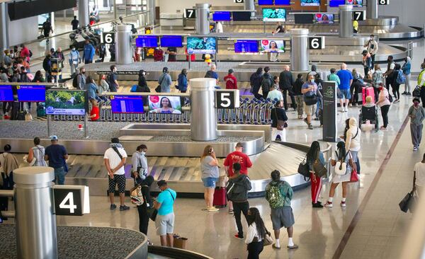 People wait for their luggage at Hartsfield-Jackson Atlanta International Airport Sunday, May 9, 2021.  STEVE SCHAEFER FOR THE ATLANTA JOURNAL-CONSTITUTION