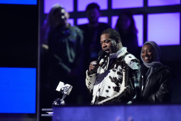 Busta Rhymes, front, accepts the 2024 MTV EMAs global icon award presented by Little Simz during the MTV European Music Awards in Manchester, England, Sunday, Nov. 10, 2024. (Scott A Garfitt/Invision/AP)