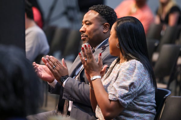 Devon Horton reacts next to his wife Christiane after the DeKalb County Board of Education hired Horton for the superintendent position at the DeKalb County Administrative Center, Wednesday, April 19, 2023, in Stone Mountain, Ga. (Jason Getz / Jason.Getz@ajc.com)