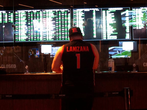 FILE - A man makes a sports bet at the Borgata casino in Atlantic City NJ on Friday March 19, 2021, the first full day of the NCAA March Madness tournament. (AP Photo/Wayne Parry,File)