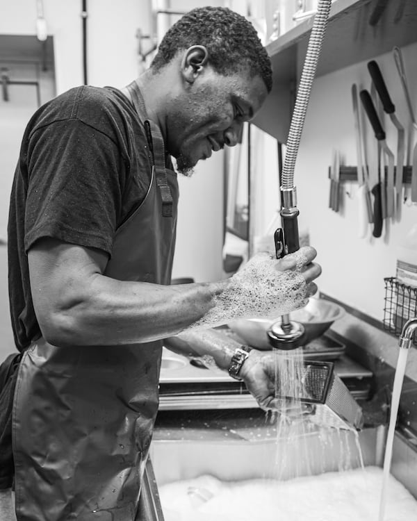 Brandon “LaBezzieB” Early washes dishes at Little Tart in Summerhill.