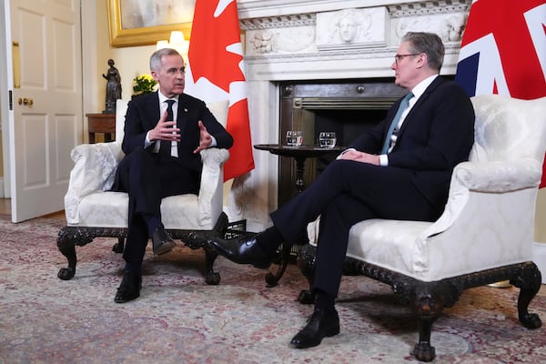 Canada Prime Minister Mark Carney meets with British Prime Minister Keir Starmer as he arrives in London on Monday, March 17, 2025. (Sean Kilpatrick/The Canadian Press via AP)