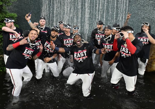 September 30, 2021 Atlanta - Atlanta Braves players celebrate after winning the NL East at Truist Park on Thursday, September 30, 2021. Atlanta Braves won 5-3 over Philadelphia Phillies. (Hyosub Shin / Hyosub.Shin@ajc.com)