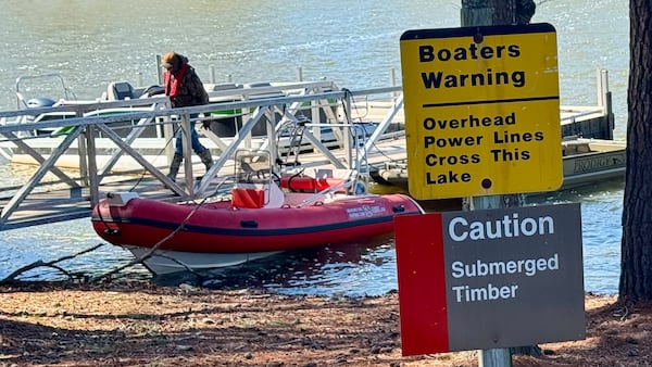 Caution signs greet boaters at the Long Shoals boat ramp on Lake Oconee in Putnam County, where search teams have staged during the two-week search for missing Atlanta boater Gary Jones. (Joe Kovac Jr. / AJC)