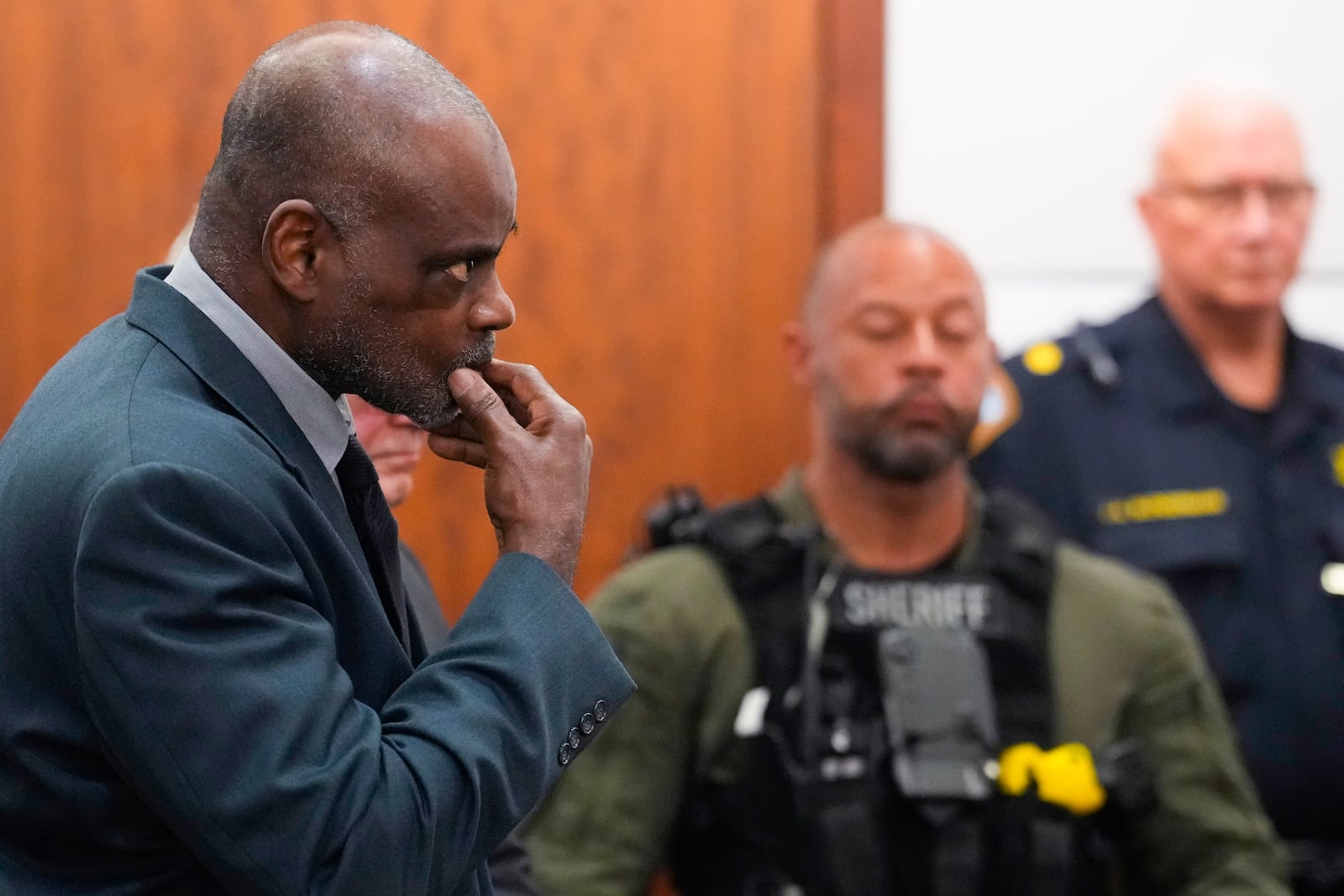 Former Houston Police officer Gerald Goines stands as he is formally sentenced on a pair of felony murder convictions on Tuesday, Oct. 8, 2024, in Houston. Goines was found guilty of felony murder and sentenced to 60 years behind bars in the 2019 deaths of Dennis Tuttle and Rhogena Nicholas. (Brett Coomer/Houston Chronicle via AP)