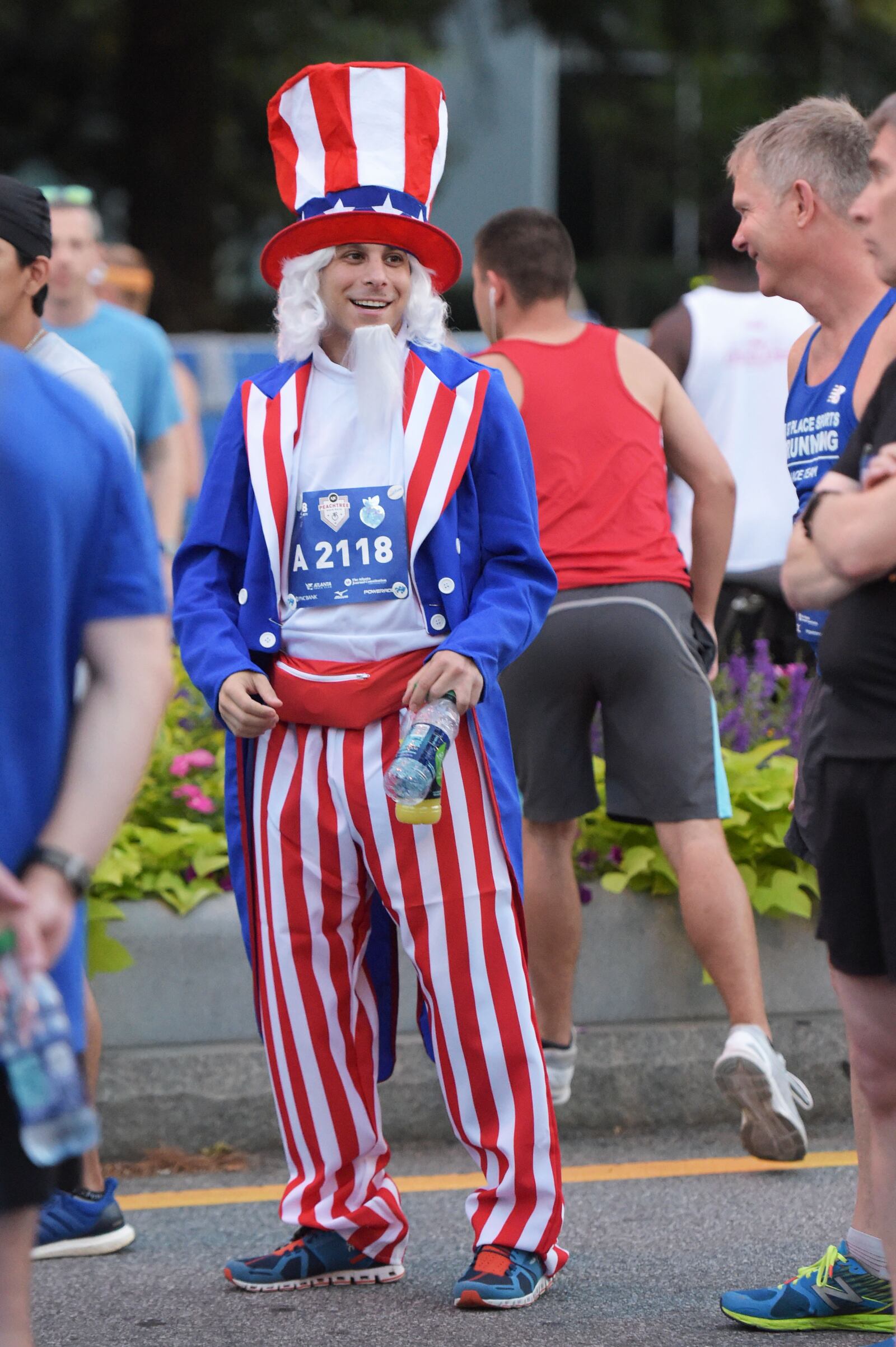 7/4/18 - Atlanta - Michael Gabriel gets ready to run in the annual AJC Peachtree Road Race on Wednesday, July 4. He says he chose to dress up to have fun. "It's not a race that I'm going to do my best at, so instead I'd rather entertain people," he says. Jenna Eason / Jenna.Eason@coxinc.com