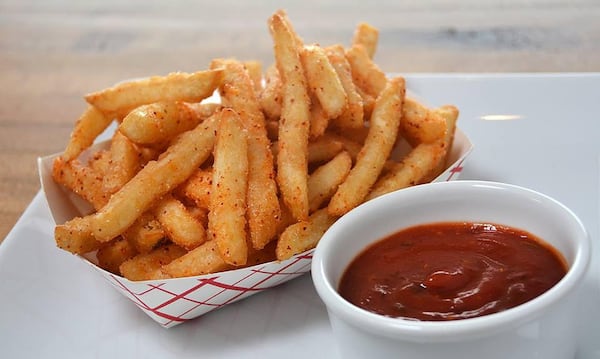 The sesame fries at Yumbii are tossed with sesame oil and a sweet-salty seasoning that includes the heat of Korean chili flakes.