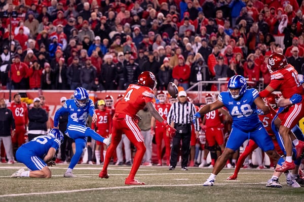 BYU place kicker Will Ferrin (44) kicks a game-winning field goal in the second half of an NCAA college football game against Utah, just after midnight on Sunday, Nov. 10, 2024, in Salt Lake City. (AP Photo/Spenser Heaps)