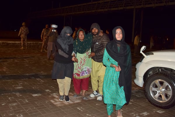 Passengers rescued by security forces from a passenger train attacked by insurgents arrive at a railway station in Quetta, Pakistan, Wednesday, March 12, 2025. (AP Photo/Arshad Butt)