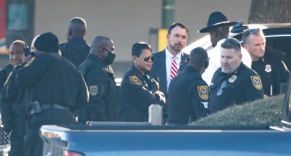 DeKalb County police Chief Mirtha Ramos (center) arrives at the scene of the manhunt along Covington Highway. 