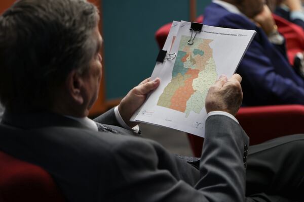 Rep. Richard Smith, R–Columbus, flips through a packet with revised congressional district maps during a reapportionment and redistricting hearing at the Georgia State Capitol on Tuesday, Dec. 5, 2023. (Natrice Miller/AJC)