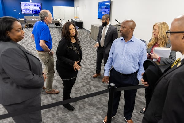 Fulton County elections board chair Sherri Allen (center) speaks to sheriff candidate Charles Rambo during Tuesday's meeting.