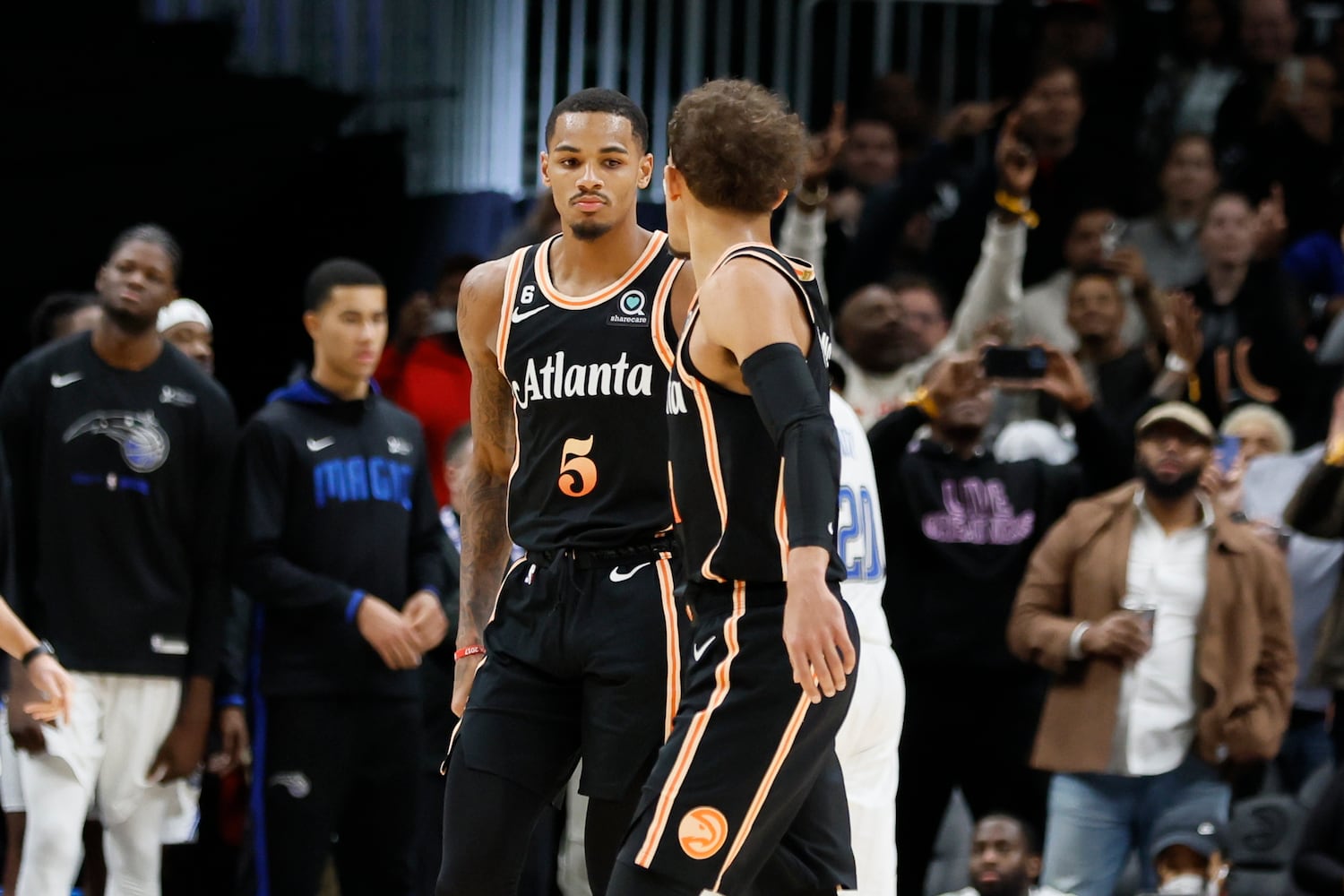 Hawks guard Dejounte Murray celebrates with guard Trae Young after Murray made two free throws at the end of the game. The host Hawks defeated the Magic 126-125 on Monday night. (Miguel Martinez / miguel.martinezjimenez@ajc.com)