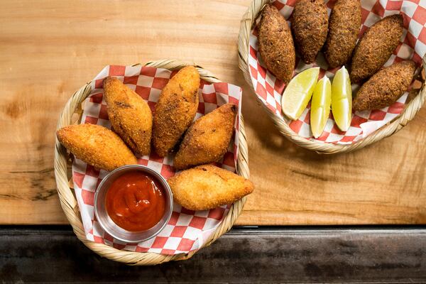 Bolinho de Mandioca com Carne (left), yucca croquettes stuffed with shredded beef with sriracha. Photo credit- Mia Yakel.