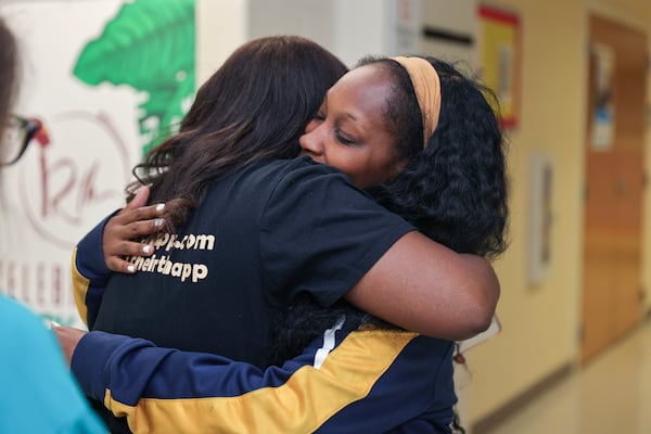 (Left to right) Kimberly Seals Allers, creator of an app called Irth hugs Joquita Hill after listening to her birth story during a launch event at Sheltering Arms Educare Center in Atlanta on Thursday, June 15, 2023. The app is  “Yelp-like” review and rating platform for Black mothers to share birthing experiences to help make Black birth safer. (Natrice Miller/ Natrice.miller@ajc.com)