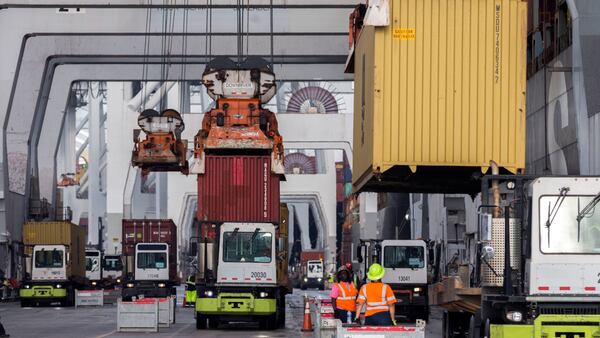 SAVANNAH, GA - DECEMBER 17, 2021: Longshoremen load and unload containers at the Georgia Ports Authority Garden City Terminal. Recently, in coordination with the U.S. Department of Transportation, the Georgia Ports Authority improved its cargo flow by increasing rail capacity and activating flexible Òpop-upÓ container yards near manufacturing and distribution centers. (AJC Photo/Stephen B. Morton)

