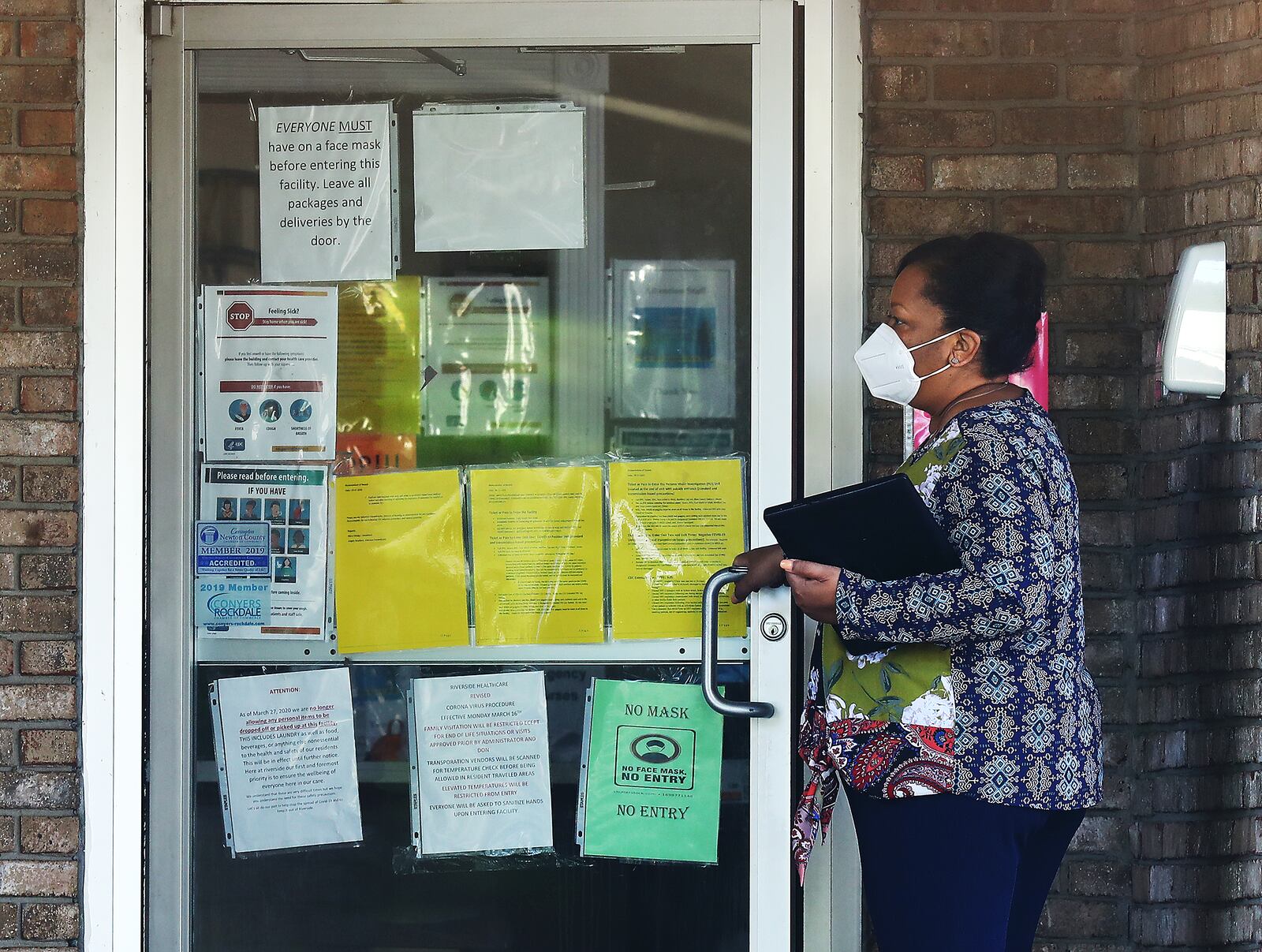 A woman enters the main entrance of Riverside Health Care Center nursing home in September. The AJC learned that DCH has determined that at least eight Georgia nursing homes, including Riverside, placed residents in “immediate jeopardy” with infection-control violations during the pandemic. (Curtis Compton / Curtis.Compton@ajc.com)