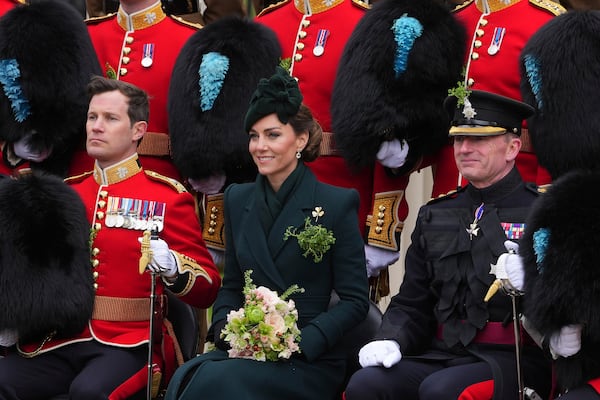 Britain's Kate, the Princess of Wales, poses for a photo with members of the Irish Guards at a special St Patrick's Day parade and celebration at Wellington Barracks in London, Monday, March 17, 2025.(AP Photo/Kirsty Wigglesworth)