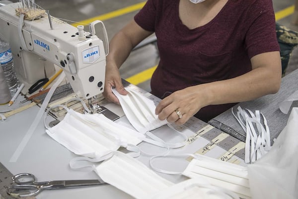 Angelica Caballero creates face masks out of fabric at Echota Fabrics, Inc. in Calhoun on April 8, 2020. Echota Fabrics, Inc. normally produces fabrics for curtains and bedding. The company’s response to the COVID19 pandemic was to create makeshift medical gowns and fabric face masks to assist healthcare workers. They are working with a local fabric manufacturer that is creating medical composite gown materials for the gowns. (ALYSSA POINTER / ALYSSA.POINTER@AJC.COM)