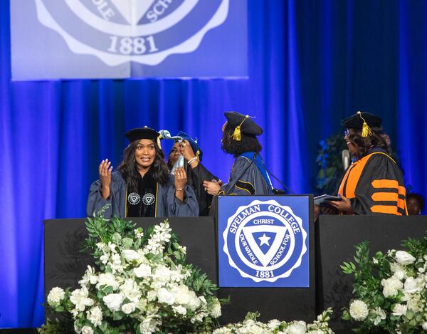 Angela Bassett, the keynote speaker, is hooded and receives an honorary degree during Spelman College’s 137th commencement at the Georgia International Convention Center on Sunday, May 19, 2024.  (Jenni Girtman for The Atlanta Journal-Constitution)