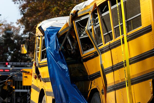 A tarp covers a section of the wreckage the day after a school bus accident in Chattanooga, Tenn.  (Credit: Doug Strickland / Chattanooga Times Free Press)