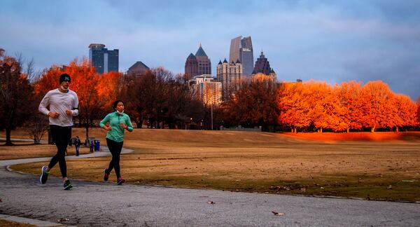 Runners run around Piedmont Park as the sun comes up Monday morning, December 21, 2020. STEVE SCHAEFER FOR THE ATLANTA JOURNAL-CONSTITUTION