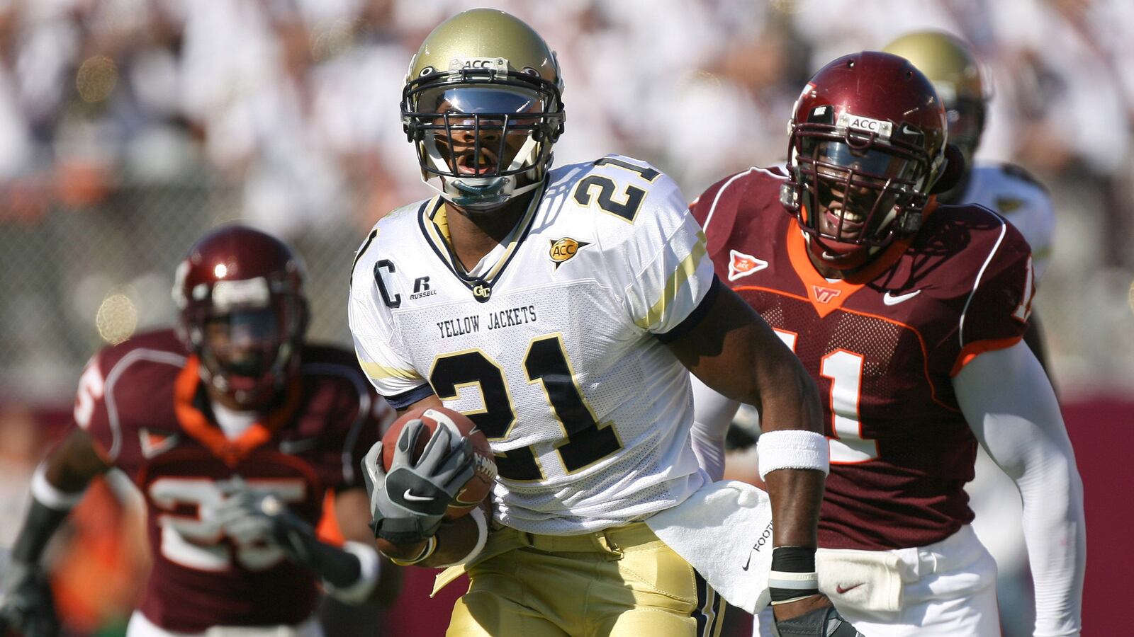 Georgia Tech's Calvin Johnson (21) runs past Virginia Tech's Xavier Adibi (11) to score his second touchdown against Virginia Tech Saturday, Sept. 30, 2006, in Blacksburg, Va.. (Johnny Crawford/AJC)