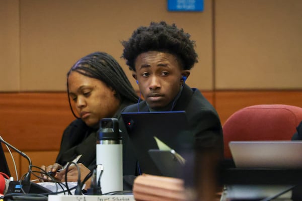 Rodalius Ryan sits next to his defense attorney during the ongoing gang and racketeering trial in Atlanta.  File photo. (Jason Getz / jason.getz@ajc.com)