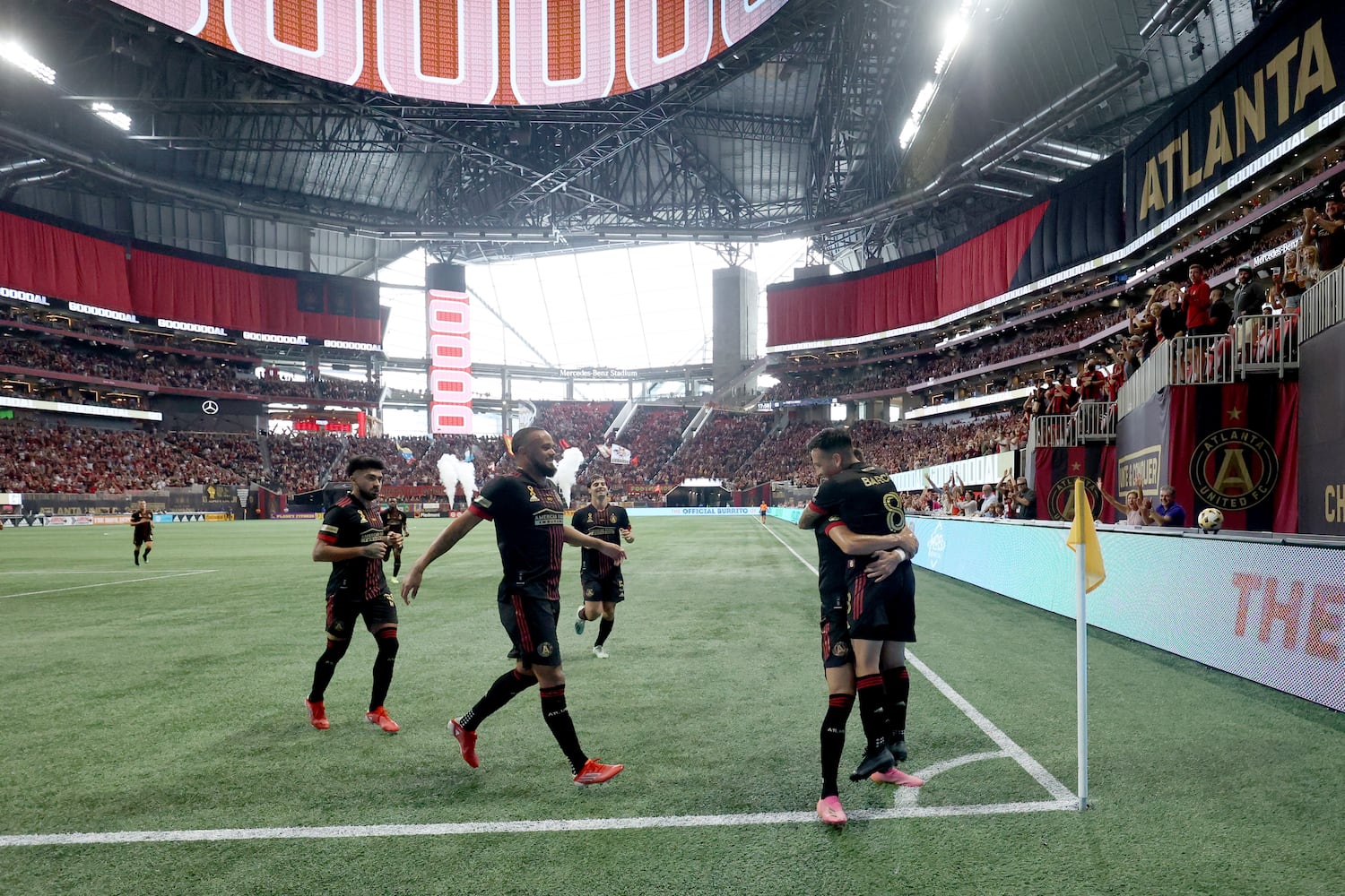 Atlanta United midfielder Ezequiel Barco (8) celebrates after scoring a goal off of a free kick with teammates during the first half against D.C. United at Mercedes-Benz Stadium Saturday, September 18, 2021 in Atlanta, Ga.. JASON GETZ FOR THE ATLANTA JOURNAL-CONSTITUTION