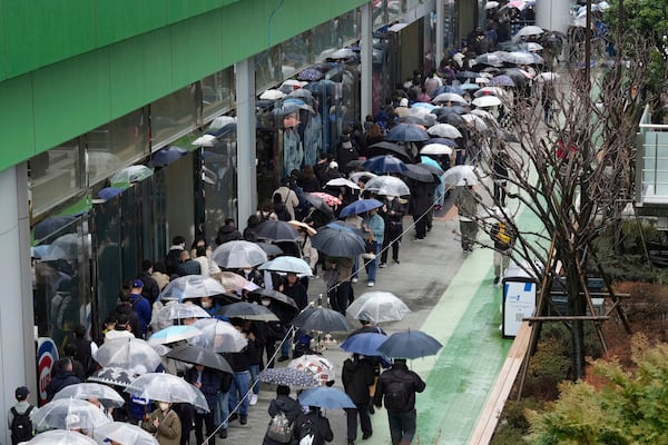 Baseball fans wait in line to get into an MLB souvenir store before the Tokyo Series exhibition games with the Los Angeles Dodgers, the Chicago Cubs, the Yomiuri Giants and the Hanshin Tigers at Tokyo Dome in Tokyo, Sunday, March 16, 2025. (AP Photo/Hiro Komae)