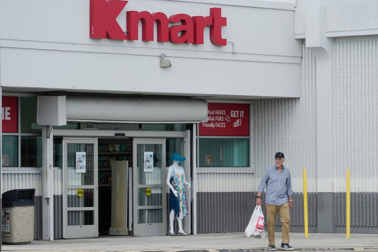 Juan de la Madriz exits the only Kmart store left in the continental United States with toys for his newborn grandson, Tuesday, Oct. 22, 2024, in Miami. (AP Photo/Marta Lavandier)