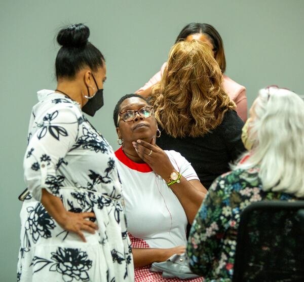 DeKalb County elections Executive Director Keisha Smith (left) and Dele Lowman Smith (seated), chairwoman of the DeKalb County elections board, talk after hours of testing machines Saturday, May 28, 2022.  A recount in a County Commission race resumed Sunday. (Photo: Jenni Girtman for The Atlanta Journal-Constitution)