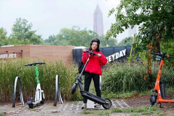 Mona Su, who lives in Midtown, lifts her scooter as she gets ready to head home after a quick trip to the market near Beltline on Monday, July 22, 2024. For Mona Su, riding scooters is a car-free lifestyle that provides an easy and reliable commuting alternative.
(Miguel Martinez / AJC)