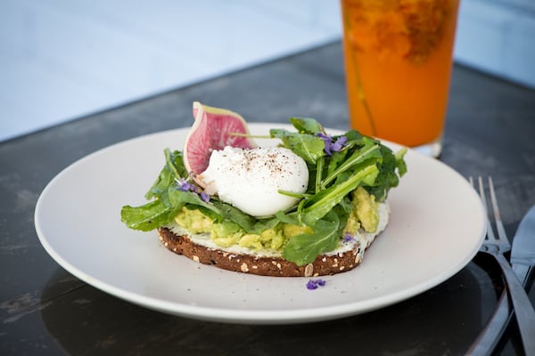  Boursin and Avocado Toast, with sprouted whole wheat toast, house boursin, avocado, dressed local greens and a poached egg. Photo credit- Mia Yakel.