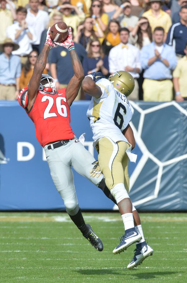 November 28, 2015 Atlanta - Georgia Bulldogs wide receiver Malcolm Mitchell (26) catches a pass under pressure from Georgia Tech Yellow Jackets defensive back Chris Milton (6) in the first half at Bobby Dodd Stadium on Saturday, November 28, 2015. HYOSUB SHIN / HSHIN@AJC.COM