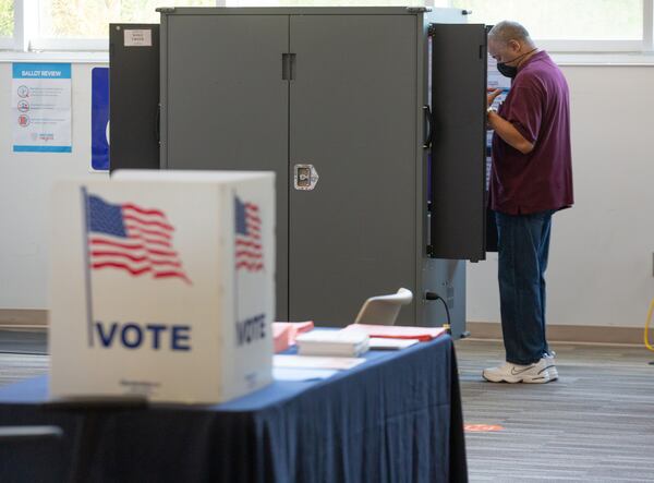 A voter casts his ballot Saturday at the Wolf Creek Library in Atlanta, where long lines forced the polling place to stay open until 10 p.m. for the June 9 Georgia primary.  STEVE SCHAEFER / SPECIAL TO THE AJC