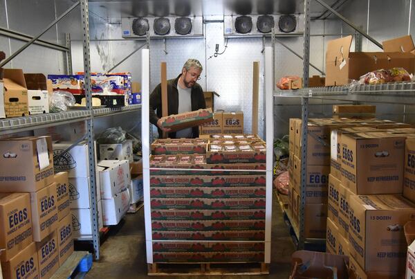 Michael Schenck, founder and chief operating officer at local food distributor Turnip Truck of Georgia, checks strawberries on Thursday, March 9, 2017. Schenk said he’s struck by the shift in growing seasons, particularly the warm spike within just the past couple of years. Strawberries, for example, arrived at Turnip Truck this year three and a half weeks earlier than last year. HYOSUB SHIN / HSHIN@AJC.COM