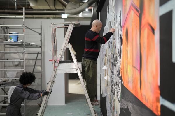 French street artist Shuck One works on a mural for the exhibition "Paris Noir", at the Centre Pompidou Museum, in Paris, Tuesday, Feb. 18, 2025. (AP Photo/Thibault Camus)