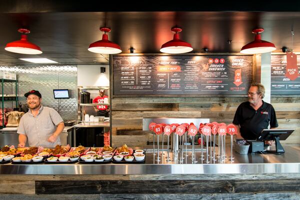 Father-and-son team Nick Bishop Jr., left, and Nick Bishop Sr. man the counter at the Hattie B’s Hot Chicken that opened last week in Little Five Points. Photo credit- Mia Yakel.