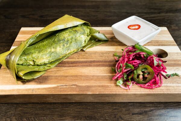 Patrani fish wrapped in banana leaf with cilantro, ginger, mint, kaffir, and onion raita at Amara. CONTRIBUTED BY MIA YAKEL