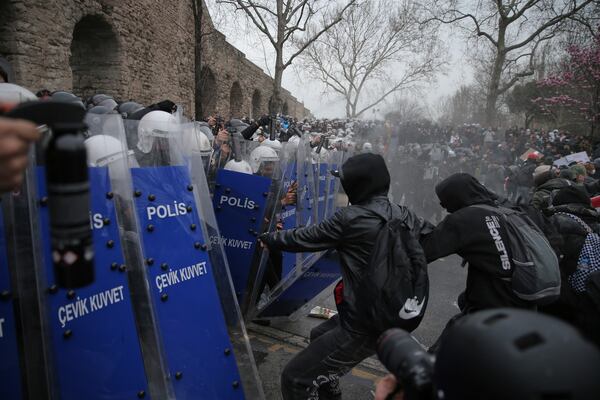 Riot police officers clash with protesters during a protest after Istanbul's Mayor Ekrem Imamoglu was arrested and sent to prison, in Istanbul, Turkey, Sunday, March 23, 2025. (AP Photo/Huseyin Aldemir)