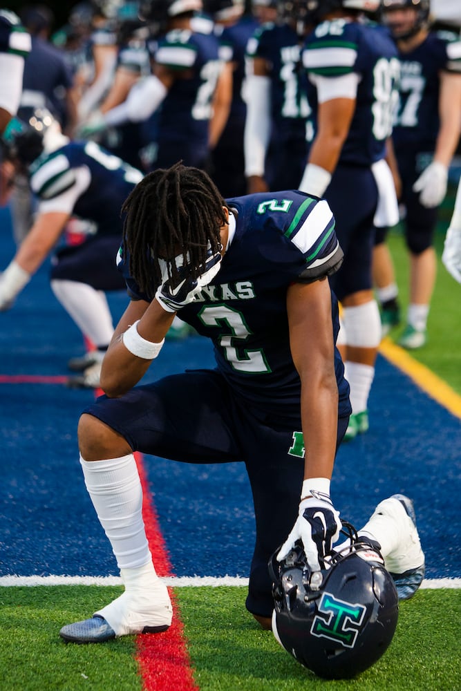 Reggie Brigman, wide receiver for Harrison, prays before the Harrison vs. Pebblebrook high school football game on Friday, September 23, 2022, at Harrison high school in Kennesaw, Georgia. Pebblebrook defeated Harrison 31-14. CHRISTINA MATACOTTA FOR THE ATLANTA JOURNAL-CONSTITUTION.